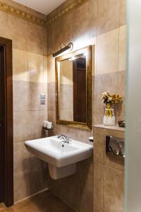 a bathroom with a sink and a mirror at Karczma Regionalna Hotel GOŚCINNA CHATA in Wysowa-Zdrój +10 photos
