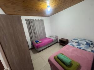 a bedroom with two beds and a wooden ceiling at René Favaloro in Rincon de los Sauces