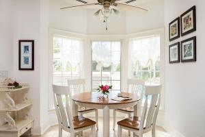 a dining room with a table and chairs and a ceiling fan at Villa with Sea View in Providenciales