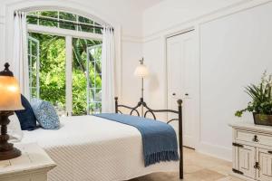 a white bedroom with a bed and a window at Villa with Sea View in Providenciales
