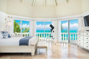 a bedroom with a bed and a view of the ocean at Villa with Sea View in Providenciales +10 photos