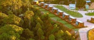 a train is traveling down a road with trees at Refúgio Tapera Bungalows & Wellness in Venda Nova do Imigrante