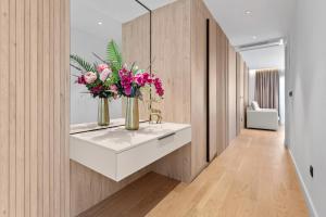 a room with two vases with flowers on a counter at VELIERO Residence by Bracera in Lugovi
