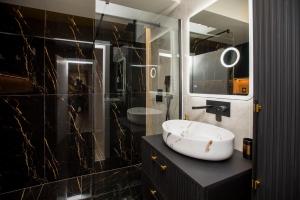 a bathroom with a sink and a mirror at Tower Apartments in Cluj-Napoca +99 photos