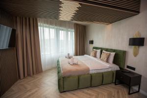 a bedroom with a large bed and a large window at Tower Apartments in Cluj-Napoca