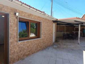 a house with a patio with a table and chairs at Casa Pampillon in Cangas de Morrazo