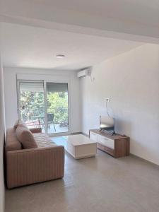 a living room with a couch and a television at Yapart in Utjeha