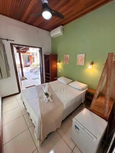 a bedroom with two beds in a room at Pousada Acquarela Paraty -a 450 mts do centro historico! we also speak English in Paraty +45 photos