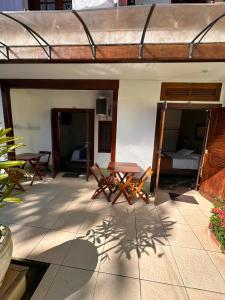 a patio with a table and chairs on a house at Pousada Acquarela Paraty -a 450 mts do centro historico! we also speak English in Paraty