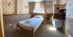 a small bedroom with a small bed in it at Windermere Bed and Breakfast in Windermere