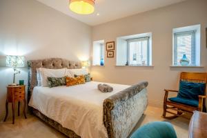a bedroom with a bed with a stuffed animal on it at 2 Bed in Porthcawl oc-87294 in Porthcawl