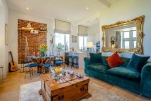 a living room with a green couch and a table at 2 Bed in Porthcawl oc-87294 in Porthcawl