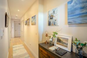 a room with a table with a painting on the wall at 2 Bed in Porthcawl oc-87294 in Porthcawl