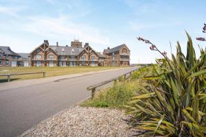 an empty road in front of a large house at 2 Bed in Porthcawl oc-87294 in Porthcawl