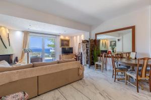 a living room with a couch and a dining room at BIG BLUE in Rafina