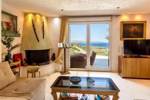 a living room with a view of the ocean at BIG BLUE in Rafina