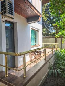 ein Balkon eines Hauses mit Geländer und Stühlen in der Unterkunft Family Hotel ADIA BLUE in Sweti Konstantin