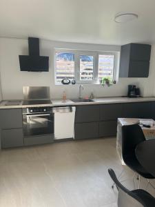 a kitchen with a sink and a stove at SeaviewHouse Rudkøbing in Rudkøbing +10 photos