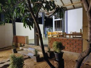 a courtyard with a tree and a brick wall at Kentz villa in Arugam Bay +24 photos