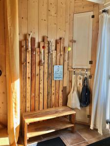 a wooden wall with a bench in a room at Espace Bulle-Zen in Burlats