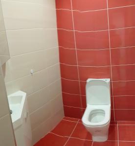 a bathroom with a toilet and a sink at Maresia BIKE ROOMS in São Félix da Marinha +13 photos