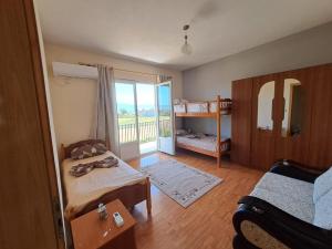 a room with a bedroom with a bed and a balcony at Villa Elezi in Culaj