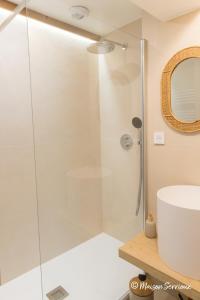 a glass shower in a bathroom with a sink at Maison Serrioux in Cholonge +27 photos