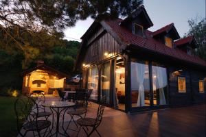 a house with a patio with a table and chairs at Lady Wine in Plešivica