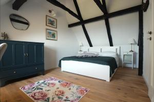 a bedroom with a bed and a dresser and a rug at Lady Wine in Plešivica