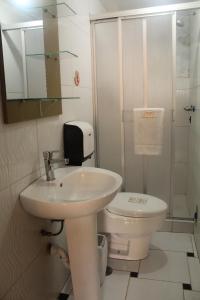 a white bathroom with a sink and a toilet at Kaaro Hotel Puno in Puno +65 photos