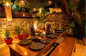 a wooden table with plates on top of it at The Peach Boho in Mount Ābu