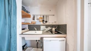 a small kitchen with a sink and a stove at Rentbeat collection 3 historic center in Ostuni