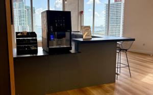 a kitchen with a counter top with a microwave at CD1608 Downtown Loft with Pool a Gym and City Views in Miami in Miami
