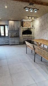 a large room with a stone fireplace and a bench at Dreams House in Yengidzha