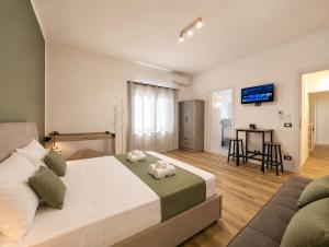 a bedroom with a large bed with two stuffed animals on it at Konero Room in Loreto