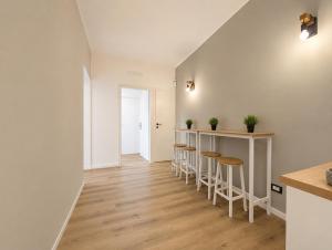 a kitchen with stools and a bar in a room at Konero Room in Loreto +32 photos