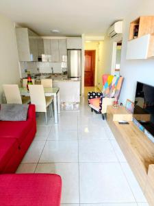 a living room with a red couch and a table at La Ola in El Médano