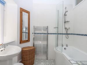 a bathroom with a tub and a sink and a toilet at Lukesland Wing in Ivybridge +34 photos
