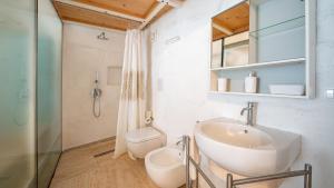 a bathroom with a sink and a toilet at Rentbeat collection 3 historic center in Ostuni +2 photos
