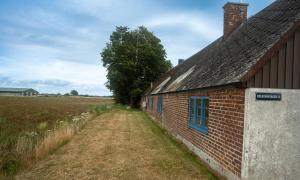 an old brick building in the middle of a field at Almeboda in Österlen in Östra Hoby