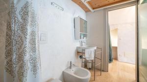 a bathroom with a urinal and a sink at Rentbeat collection 3 historic center in Ostuni