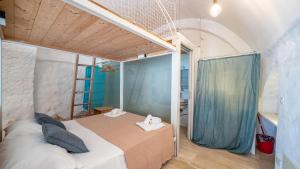 a bedroom with a bed with a blue curtain at Rentbeat collection 3 historic center in Ostuni