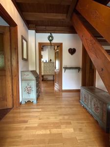 an attic room with wooden floors and a staircase at Room Dolomites ''Antelao'' in San Vito di Cadore