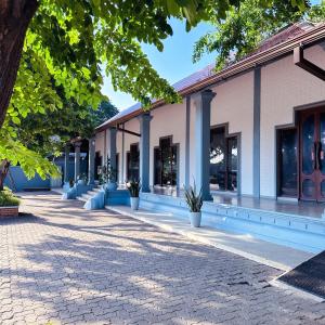 a building with potted plants in front of it at Roy's Polonnaruwa in Polonnaruwa