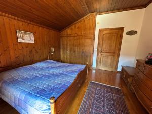 a bedroom with a bed and a wooden ceiling at Room Dolomites ''Antelao'' in San Vito di Cadore