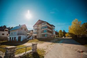 a large apartment building on a dirt road at Orange stan in Žabljak