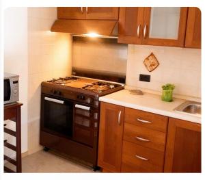 a kitchen with a stove and a sink at Casa Panorama in Monte di Procida