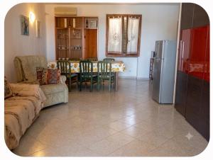 a living room with a couch and a table and a refrigerator at Casa Panorama in Monte di Procida