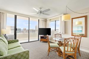 a living room with a couch and a table at Royal Kuhio Resort in Honolulu