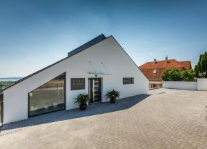 a white house with a black roof at Villa Rima in Vonyarcvashegy